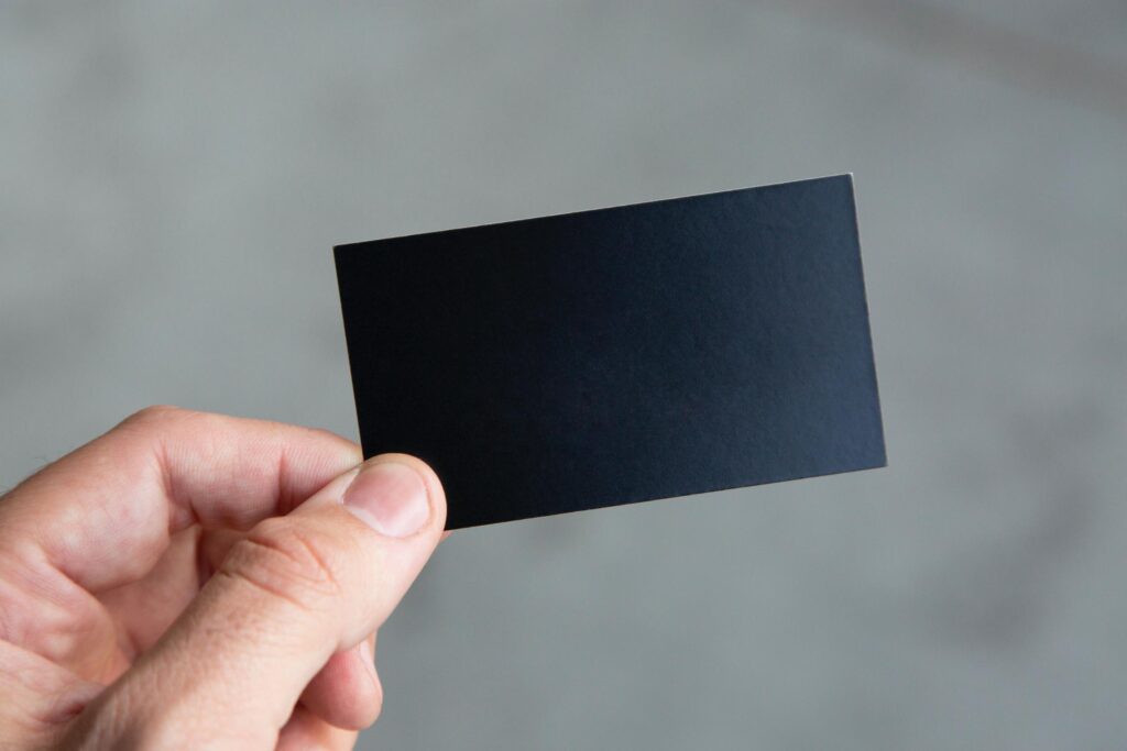 A person holding up a black card