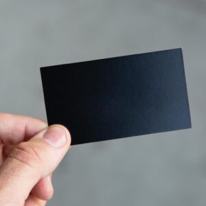 A person holding up a black card